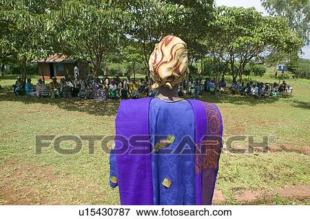 Stock Photo - Sarah Kilemi, wife of Parliament member Kilemi Mwiria, speaks to "Women without Husbands" women who have been ostracized from society or who have lost their husbands and only have themselves as a group to look after each other in Meru, Kenya, Africa. Fotosearch