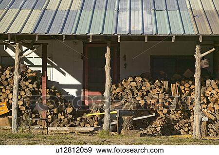 Stock Photo - Stack of logs in front of cabin in Mescalero Apache Indian Reservation near Ruidoso and Alto, New Mexico. Fotosearch