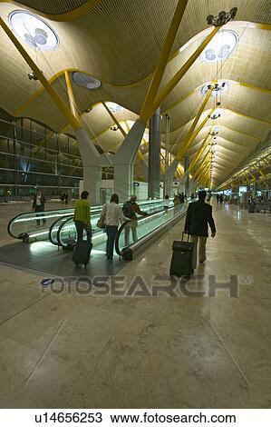 Travelers on moving sidewalk at Madrid Barajas Airport (MAD), Spain's busiest airport View Large Photo Image Stock Image - Travelers on moving sidewalk at Madrid Barajas Airport (MAD), Spain's busiest airport. Fotosearch