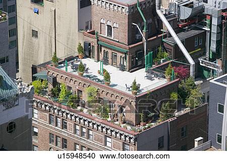 Trees and plants grow on outdoor deck of New York City apartment building in Manhattan, New York View Large Photo Image Stock Image - Trees and plants grow on outdoor deck of New York City apartment building in Manhattan, New York. Fotosearch