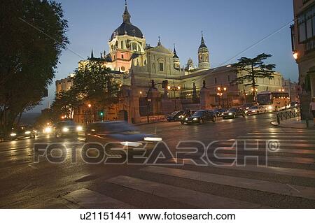 Stock Image - Twilight and lights coming on at Royal Palace in Madrid, Spain. Fotosearch