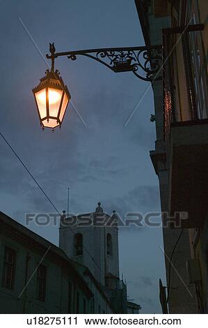 Stock Image - Twilight scene of lamp light and buildings in historic and popular tourist area, Barrio Alta, Lisbon/Lisboa Portugal. Fotosearch