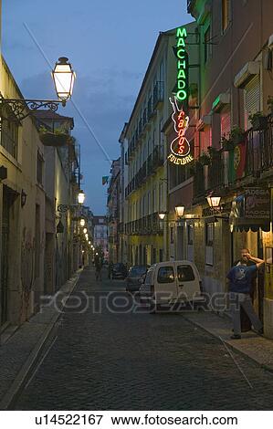 Stock Photo - Twilight scene of lamp light and buildings in historic and popular tourist area, Barrio Alta, Lisbon/Lisboa Portugal. Fotosearch