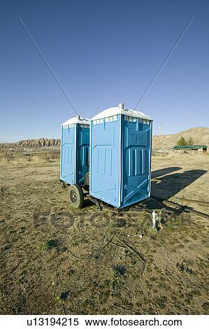 Two out houses, mobile blue bathrooms, sit on trailer in the middle of a field in Ventura County, California off of highway 33 near Cuyama View Large Photo Image Stock Photography - Two out houses, mobile blue bathrooms, sit on trailer in the middle of a field in Ventura County, California off of highway 33 near Cuyama. Fotosearch