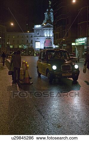 Wet night streets of West End of London's theater district with taxi driving by, England View Large Photo Image Stock Photograph - Wet night streets of West End of London's theater district with taxi driving by, England. Fotosearch