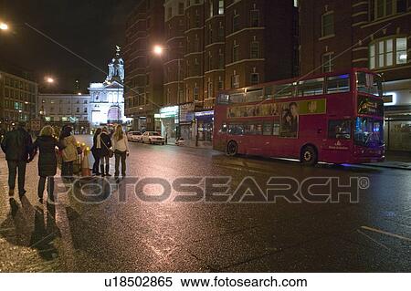 Wet night streets of West End of London's theater district with double decker bus driving by, England View Large Photo Image Stock Photography - Wet night streets of West End of London's theater district with double decker bus driving by, England. Fotosearch