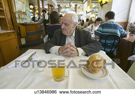100 year old man sits down to a mug of beer and a loaf of bread in a restaurant in Madrid, Spain View Large Photo Image Stock Photograph - 100 year old man sits down to a mug of beer and a loaf of bread in a restaurant in Madrid, Spain. Fotosearch