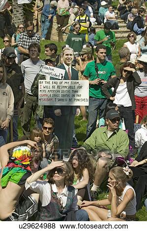 A cutout of George W. Bush saying "Mission Accomplished" stands in front of a crowd of protesters on a grass lawn at an anti-Iraq War protest march in Santa Barbara, California on March 17, 2007 View Large Photo Image Stock Photo - A cutout of George W. Bush saying "Mission Accomplished" stands in front of a crowd of protesters on a grass lawn at an anti-Iraq War protest march in Santa Barbara, California on March 17, 2007. Fotosearch