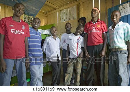 Stock Photo - A group of young Kenyan males, who are affected with HIV/AIDS, pose for camera at Pepo La Tumaini Jangwani, HIV/AIDS Community Rehabilitation Program, Orphanage & Clinic. Pepo La Tumaini Jangwani (wind of hope in the arid place) offers hope, support and . Fotosearch