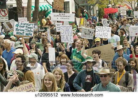 A large crowd of protesters march and chant down State Street carrying signs at an anti-Iraq War protest march in Santa Barbara, California on March 17, 2007 View Large Photo Image Stock Image - A large crowd of protesters march and chant down State Street carrying signs at an anti-Iraq War protest march in Santa Barbara, California on March 17, 2007. Fotosearch