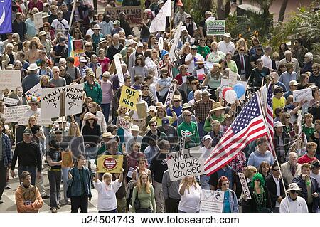 Stock Image - A large crowd of protesters march and chant down State Street carrying signs at an anti-Iraq War protest march in Santa Barbara, California on March 17, 2007. Fotosearch