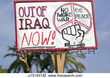 A man gives the peace sign and holds a sign saying, "Out of Iraq Now" at an anti-Iraq War protest march in Santa Barbara, California on March 17, 2007 View Large Photo Image Stock Image - A man gives the peace sign and holds a sign saying, "Out of Iraq Now" at an anti-Iraq War protest march in Santa Barbara, California on March 17, 2007. Fotosearch