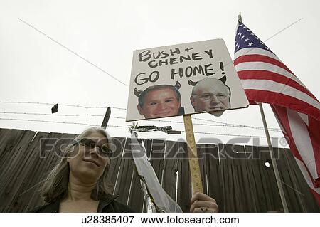 A sign shows President Bush and VP Cheney as the devil with the US Flag at an anti-Iraq War protest march in Santa Barbara, California on March 17, 2007 View Large Photo Image Stock Photo - A sign shows President Bush and VP Cheney as the devil with the US Flag at an anti-Iraq War protest march in Santa Barbara, California on March 17, 2007. Fotosearch