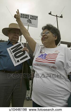 A woman protester gives the peace sign at an anti-Iraq War protest march in Santa Barbara, California on March 17, 2007 View Large Photo Image Stock Photo - A woman protester gives the peace sign at an anti-Iraq War protest march in Santa Barbara, California on March 17, 2007. Fotosearch