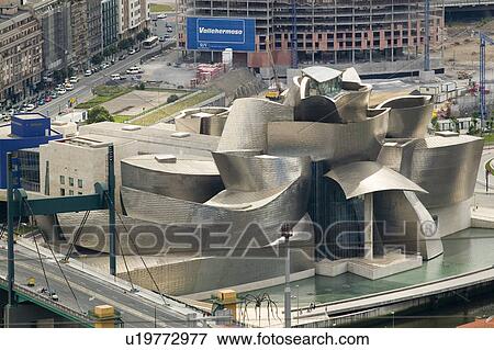 Aerial view of the Guggenheim Museum of Contemporary Art of Bilbao (Bilbo) located on the North Coast of Spain in the Basque region. Nicknamed "The Hole", this is a contemporary museum built of titanium, limestone and glass and was designed by Canadian ci View Large Photo Image Stock Photo - Aerial view of the Guggenheim Museum of Contemporary Art of Bilbao (Bilbo) located on the North Coast of Spain in the Basque region. Nicknamed "The Hole", this is a contemporary museum built of titanium, limestone and glass and was designed by Canadian ci. Fotosearch