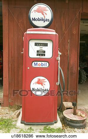 Stock Photograph - Antique Mobil gas pump in front of red barn off Manchester road, Missouri. Fotosearch