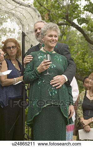 Stock Image - Bride, groom and guests share wine at a traditional Jewish wedding in Ojai, CA. Fotosearch
