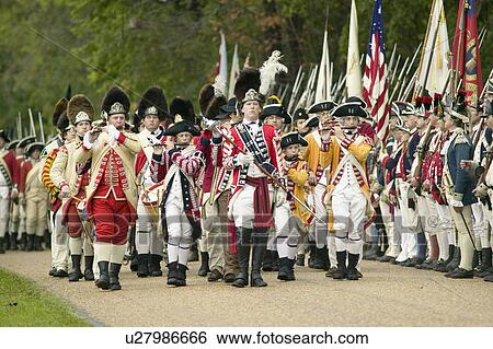 Stock Photograph - British Musicians march at Surrender Field at the 225th Anniversary of the Victory at Yorktown, a reenactment of the siege of Yorktown, where General George Washington commanded 17, 600 American troops and French Comte de Rochambeau lead 5500 French troops. Fotosearch