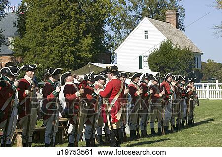 Stock Image - British soldiers toast to the King of England in front of the Digges House, built in 1775 in Yorktown, Virginia. First owner Dudley Digges' house now resides in the Colonial National Historical Park, Historical Triangle, as part of the 225th anniversary o. Fotosearch
