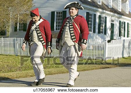 Stock Photo - British soldiers walk in front of the Digges House, built in 1775 in Yorktown, Virginia. First owner Dudley Digges' house now resides in the Colonial National Historical Park, Historical Triangle, Virginia.. Fotosearch