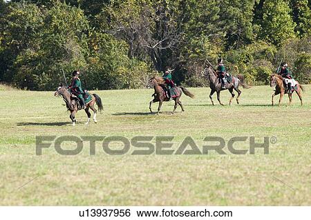 Stock Photograph - Continental Dragoons charging the square on horseback, a combined charge of the 2nd and 4th Regiment Light Dragoons against a Loyalist square at repel cavalry, End View Plantation. Fotosearch