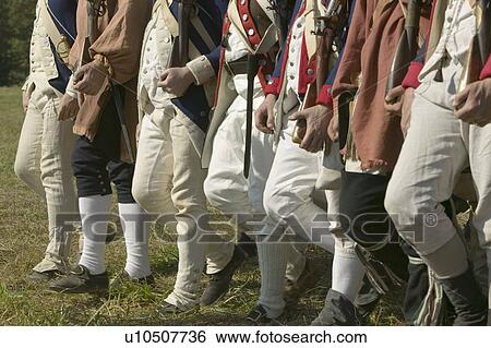 Stock Photograph - Continentals on the march in re-enactment of Attack on Redoubts 9 & 10, where the major infantry action of the siege of Yorktown took place. General Washington's armies captured two British fortifications, Endview Plantation (circa 1769), near Yorktown Vi. Fotosearch