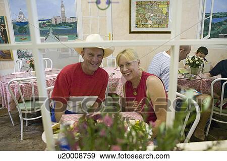 Couple dressed in red, white and blue relax in café during Fourth of July celebration in Ojai, CA View Large Photo Image Stock Photo - Couple dressed in red, white and blue relax in café during Fourth of July celebration in Ojai, CA. Fotosearch