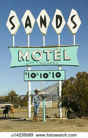 Cowboy leans against post in front of Sands Motel sign with RV Parking for $10, at the intersection of Route 54 & 380 in Carrizozo, New Mexico View Large Photo Image Stock Photo - Cowboy leans against post in front of Sands Motel sign with RV Parking for $10, at the intersection of Route 54 & 380 in Carrizozo, New Mexico. Fotosearch
