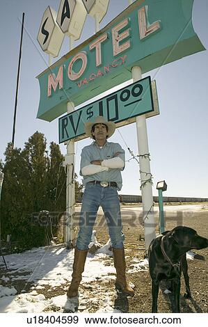 Cowboy with dog stand in front of Sands Motel sign with RV Parking for $10, located at the intersection of Route 54 & 380 in Carrizozo, New Mexico View Large Photo Image Stock Photo - Cowboy with dog stand in front of Sands Motel sign with RV Parking for $10, located at the intersection of Route 54 & 380 in Carrizozo, New Mexico. Fotosearch