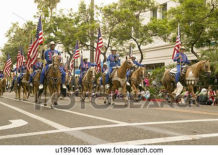 Cowboys on horseback with American Flags displayed during opening day parade down State Street, Santa Barbara, CA, Old Spanish Days Fiesta, August 2006 View Large Photo Image Stock Image - Cowboys on horseback with American Flags displayed during opening day parade down State Street, Santa Barbara, CA, Old Spanish Days Fiesta, August 2006. Fotosearch