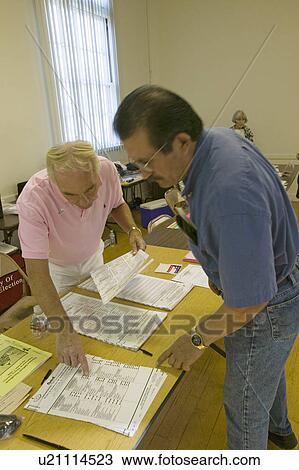 Stock Image - Election worker helps explains ballot for Congressional election, November 2006, in Ojai, Ventura County, California. Fotosearch