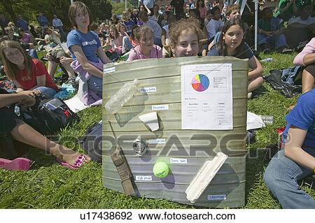 Stock Image - Female student displays junk pulled out of river area for Earth Day event in Alexandria, Virginia for Earth Force. Fotosearch