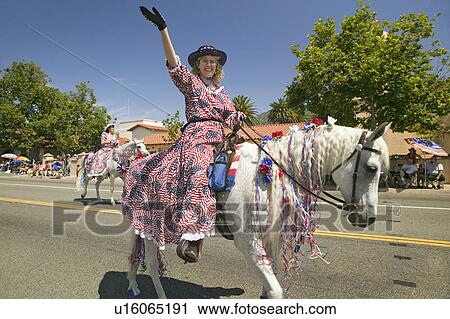 Festive decorated horse and rider make their way down main street during a Fourth of July parade in Ojai, CA View Large Photo Image Stock Image - Festive decorated horse and rider make their way down main street during a Fourth of July parade in Ojai, CA. Fotosearch
