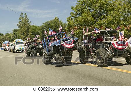 Flag adorned jeeps demonstrate 4 wheel maneuvers as they make their way down main street during a Fourth of July parade in Ojai, CA View Large Photo Image Stock Photography - Flag adorned jeeps demonstrate 4 wheel maneuvers as they make their way down main street during a Fourth of July parade in Ojai, CA. Fotosearch