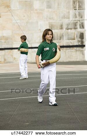 Stock Photo - French Boy plays Jai li in Sare, France, a 17th century village in Basque Country on the Spanish-French border, near St. Jean de Luz, on the Cote Basque, South West France. Fotosearch