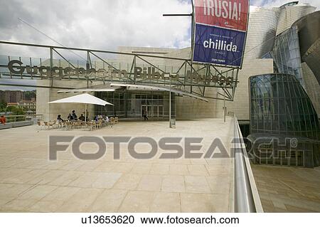 Front entrance of the Guggenheim Museum of Contemporary Art of Bilbao (Bilbo), located on the North Coast of Spain in the Basque region. Nicknamed "The Hole", this is a contemporary museum built of titanium, limestone and glass and was designed by Canadia View Large Photo Image Stock Image - Front entrance of the Guggenheim Museum of Contemporary Art of Bilbao (Bilbo), located on the North Coast of Spain in the Basque region. Nicknamed "The Hole", this is a contemporary museum built of titanium, limestone and glass and was designed by Canadia. Fotosearch