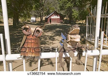 Picture - Funny folk art of owl and dinosaur sitting on fence.. Fotosearch