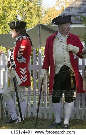 Stock Photo - General Charles O'Hara leans on fence with British Officer in Yorktown, Virginia, as part of the 225th anniversary of the Siege of Yorktown, a reenactment of the 1781 defeat of the British Army and the end of the American Revolution.. Fotosearch