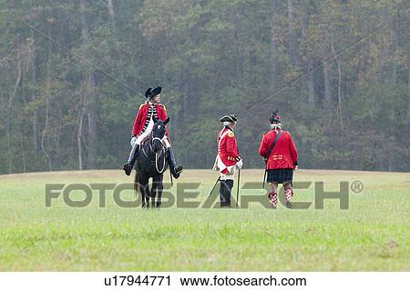 Stock Image - General Charles O'Hara surrenders to General George Washington at the 225th Anniversary of the Victory at Yorktown, a reenactment of the siege of Yorktown, where General George Washington commanded 17, 600 American troops and French Comte de Rochambeau lea. Fotosearch