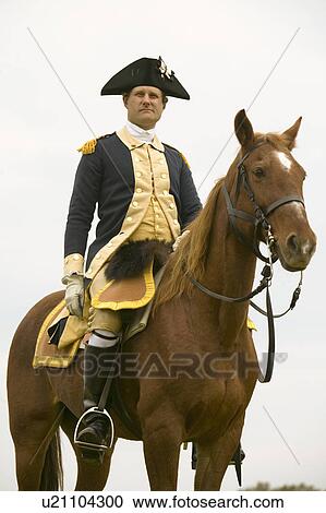 Stock Image - General Washington looks over his troops prior to march from camp to the Surrender Field at the 225th Anniversary of the Victory at Yorktown, a reenactment of the siege of Yorktown, where General George Washington commanded 17, 600 American troops and Fren. Fotosearch