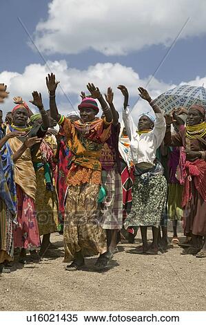 Grandmothers, who are the caretakers of their children and grandchildren who are infected with HIV/AIDS, dance at Pepo La Tumaini Jangwani, HIV/AIDS Community Rehabilitation Program, Orphanage & Clinic. Pepo La Tumaini Jangwani (wind of hope in the arid View Large Photo Image Stock Photography - Grandmothers, who are the caretakers of their children and grandchildren who are infected with HIV/AIDS, dance at Pepo La Tumaini Jangwani, HIV/AIDS Community Rehabilitation Program, Orphanage & Clinic. Pepo La Tumaini Jangwani (wind of hope in the arid . Fotosearch