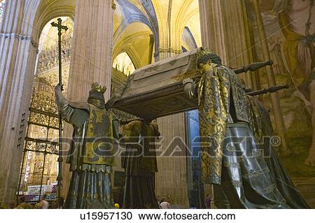 Stock Image - In the Sevilla Cathedral, Southern Spain, is the mausoleum-monument and ornate tomb of Christopher Columbus where four heralds dressed in full court mourning carry the sarcophagus; they bear respectively the arms of, Castile, Léon, Aragon, and Navarre, th. Fotosearch