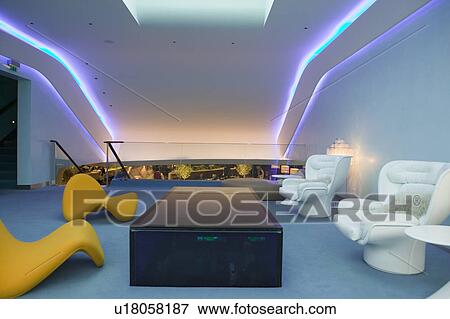 Stock Photo - Interior view of modern seating furniture in first class lounge of Virgin Airlines at Heathrow Airport in London, England, United Kingdom. Fotosearch