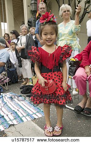 Stock Photo - Japanese American girl is in bright red Mexican dress at annual Old Spanish Days Fiesta held every August in Santa Barbara, California. Fotosearch
