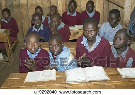 Stock Image - Karimba School with school children at their desk in classroom in North Kenya, Africa. Fotosearch