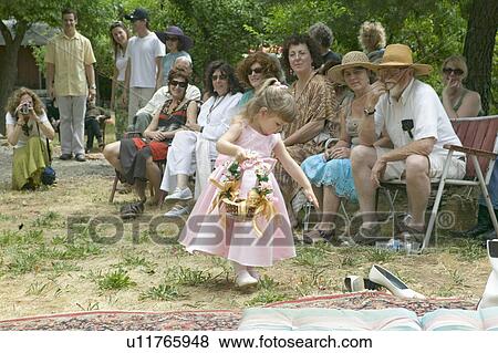 Stock Photo - Little girl with basket of flowers at a traditional Jewish wedding in Ojai, CA. Fotosearch