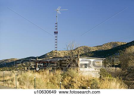 Stock Photo - Log cabin with TV antenna on Mescalero Apache Indian Reservation near Ruidoso and Alto, New Mexico. Fotosearch