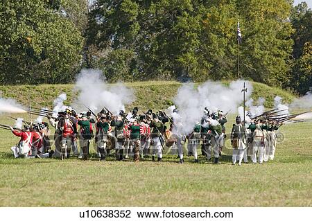 Stock Image - Loyalist square fires in all directions at once as Continental Dragoons charge on horseback, a combined charge of the 2nd and 4th Regiment Light Dragoons against a Loyalist square at repel cavalry, End View Plantation . Fotosearch