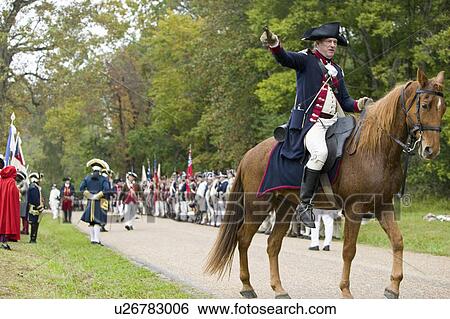 Stock Photograph - Major General Benjamin Lincoln on horseback rides down Surrender Road at the 225th Anniversary of the Victory at Yorktown, a reenactment of the siege of Yorktown, where General George Washington commanded 17, 600 American troops and French Comte de Rochamb. Fotosearch