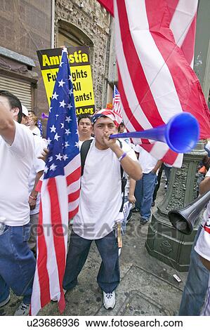 Man blows horn with hundreds of thousands of immigrants participating in march for Immigrants and Mexicans protesting against Illegal Immigration reform by U. S. Congress, Los Angeles, CA, May 1, 2006 View Large Photo Image Stock Photograph - Man blows horn with hundreds of thousands of immigrants participating in march for Immigrants and Mexicans protesting against Illegal Immigration reform by U. S. Congress, Los Angeles, CA, May 1, 2006. Fotosearch